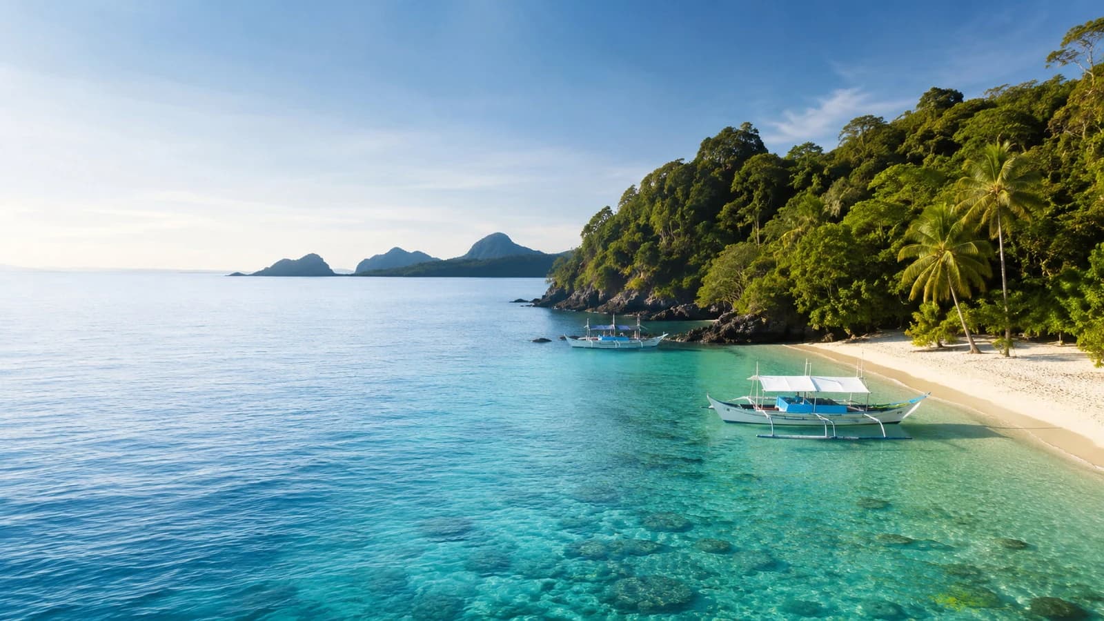 Tropical Philippines coastline with clear water and an outrigger boat