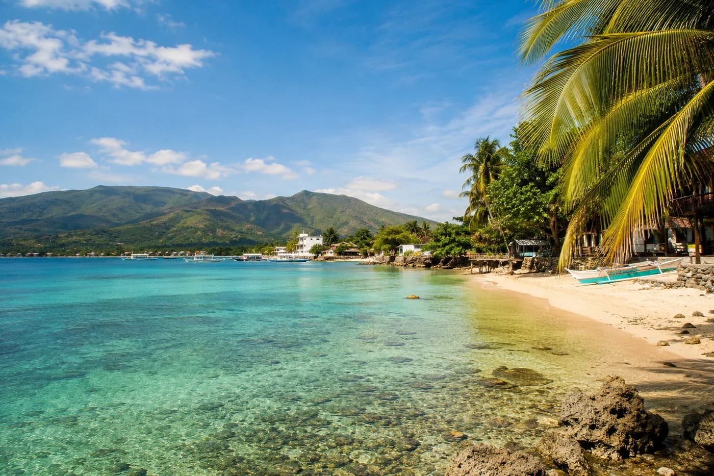 Tropical Cebu coastline with clear blue water and green hills